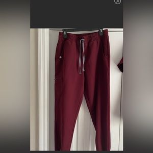 Very high waisted with scrunch waistband. Scuff on knee. Worn twice. Maroon